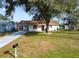 Charming single-story home with a lovely front yard and mature trees providing shade at 9608 Theresa Dr, Thonotosassa, FL 33592