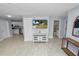 Open concept living room showcasing the light tile flooring and flow into the kitchen and bathroom at 9608 Theresa Dr, Thonotosassa, FL 33592