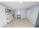 Bright living room with wood-look tile flooring and a wall-mounted television at 9608 Theresa Dr, Thonotosassa, FL 33592