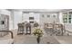 Open concept kitchen features island with seating, stainless steel appliances, and dining area at 1970 Blackwood Cir, North Port, FL 34286