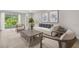 Bright living room featuring a comfy sofa and large windows at 1970 Blackwood Cir, North Port, FL 34286