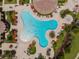 Aerial view of resort-style pool with surrounding lounge chairs and umbrellas at 20625 Romagna Pl, Venice, FL 34293