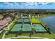Well-maintained tennis courts with surrounding landscaping and lake views at 20625 Romagna Pl, Venice, FL 34293