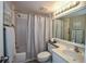 Clean bathroom, shower/tub combo, light vanity, and linen storage at 266 Cerromar S Way # 55, Venice, FL 34293