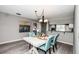 Dining room with white table and blue chairs at 266 Cerromar S Way # 55, Venice, FL 34293