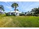 White house with palm tree and grassy yard at 266 Cerromar S Way # 55, Venice, FL 34293
