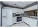 Bright white kitchen features granite countertops and modern appliances at 266 Cerromar S Way # 55, Venice, FL 34293