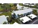 Aerial view of a light blue condo building with white roof, carports, and landscaping at 448 Cerromar Rd # 286, Venice, FL 34293