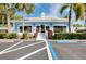 Community clubhouse with palm trees and parking at 448 Cerromar Rd # 286, Venice, FL 34293