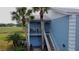 Light blue condo building exterior with stairs and a balcony at 448 Cerromar Rd # 286, Venice, FL 34293