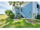Light blue condo building exterior with stairs and landscaping at 448 Cerromar Rd # 286, Venice, FL 34293