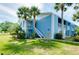 Light blue condo building exterior with stairs and landscaping at 448 Cerromar Rd # 286, Venice, FL 34293