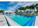 Relaxing community pool with lounge chairs and umbrellas at 448 Cerromar Rd # 286, Venice, FL 34293