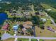 Expansive aerial view of the home, pool, water features, and lush landscaping at 1061 Owl Dr, Englewood, FL 34223