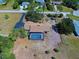 Wide aerial view of a house with a screened pool and large yard at 1061 Owl Dr, Englewood, FL 34223