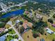 Aerial view of a home surrounded by lakes and trees, showcasing the expansive property at 1061 Owl Dr, Englewood, FL 34223