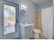 Light and airy bathroom with a modern vanity, decorative mirror, and walk-in shower with curtain at 1061 Owl Dr, Englewood, FL 34223