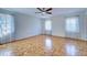Spacious bedroom with parquet floors, ceiling fan and bright natural light at 1061 Owl Dr, Englewood, FL 34223