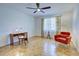Bedroom featuring bright windows, curtains, and a decorative desk, chair, and lamp at 1061 Owl Dr, Englewood, FL 34223
