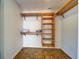 Walk-in closet features built in wooden shelving and organizers at 1061 Owl Dr, Englewood, FL 34223