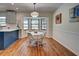 Cozy dining room with a large bay window and warm wood floors at 1061 Owl Dr, Englewood, FL 34223