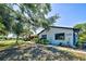 Home exterior with large windows, manicured landscaping, and a modern, minimalist design at 1061 Owl Dr, Englewood, FL 34223