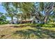 Attractive home featuring a well-maintained lawn and mature, shade-providing trees at 1061 Owl Dr, Englewood, FL 34223