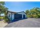 Spacious garage with a modern design and ample parking space, complemented by well-maintained landscaping at 1061 Owl Dr, Englewood, FL 34223
