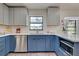 Beautiful kitchen includes a stainless steel dishwasher, faucet, and a view of the outdoor scenery at 1061 Owl Dr, Englewood, FL 34223