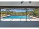 Large screened pool with a spacious seating area has a peaceful backyard view at 1061 Owl Dr, Englewood, FL 34223