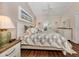 Bright main bedroom with a king-size bed and stylish decor at 129 Preserve Pl # D, Nokomis, FL 34275