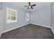 Well-lit bedroom with neutral walls and carpeting at 5515 Reisterstown Rd, North Port, FL 34291