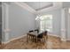 Bright dining room with glass-top table and chandelier at 5515 Reisterstown Rd, North Port, FL 34291