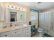 Charming bathroom with a white vanity, shower, and decorative touches at 566 Viridian St, Englewood, FL 34223