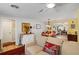 Bright dining room with a wooden table, red chairs, and access to the kitchen at 566 Viridian St, Englewood, FL 34223