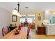 Open concept dining area with red chairs, a farmhouse table and view of the kitchen at 566 Viridian St, Englewood, FL 34223