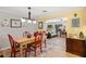 Bright dining room with red chairs, a farmhouse table and view into the Gathering room at 566 Viridian St, Englewood, FL 34223