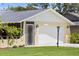 Home's exterior featuring a garage and well-maintained landscaping at 566 Viridian St, Englewood, FL 34223