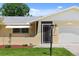 Front entrance with a screened porch and updated door at 566 Viridian St, Englewood, FL 34223