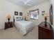 Cozy bedroom with a queen-size bed and a ceiling fan at 344 Bermuda Ct # 4, Venice, FL 34293