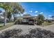 Carport with vehicle parked, adjacent to manicured landscaping at 429 Wexford Cir # 75, Venice, FL 34293