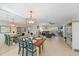 Bright dining area with wooden table and teal chairs at 429 Wexford Cir # 75, Venice, FL 34293