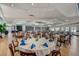 Elegant community clubhouse dining room with tables set for a meal at 429 Wexford Cir # 75, Venice, FL 34293