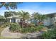 Exterior view of a light blue house with lush landscaping and a paved walkway at 429 Wexford Cir # 75, Venice, FL 34293