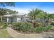 Brightly lit home exterior with lush landscaping and walkway at 429 Wexford Cir # 75, Venice, FL 34293