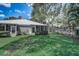 View of home from backyard showing sunroom and lush grass at 429 Wexford Cir # 75, Venice, FL 34293