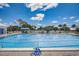 Refreshing community pool with lounge chairs and sunny skies at 429 Wexford Cir # 75, Venice, FL 34293