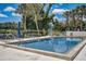 Community pool with lounge chairs and umbrellas at 429 Wexford Cir # 75, Venice, FL 34293