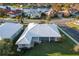 Aerial view of single-Gathering home with white tile roof and screened enclosure at 664 Silk Oak Dr, Venice, FL 34293