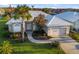 Single-Gathering home exterior, tile roof, two-car garage, and palm trees at 664 Silk Oak Dr, Venice, FL 34293